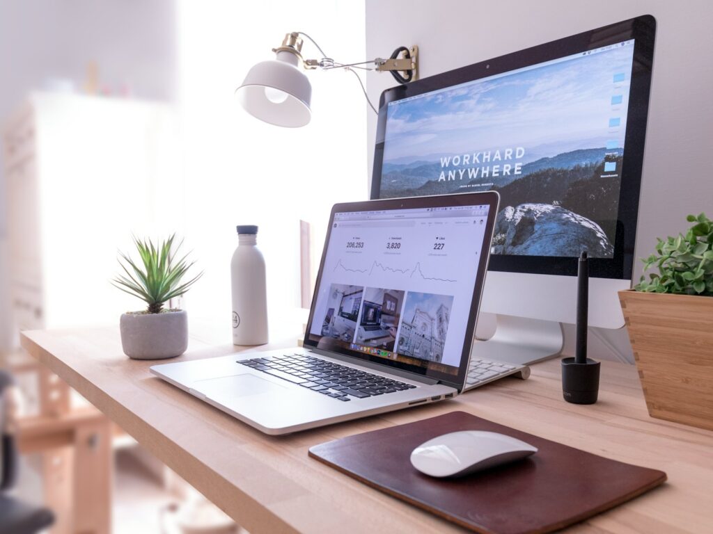 Laptop and desktop computer on an office desk