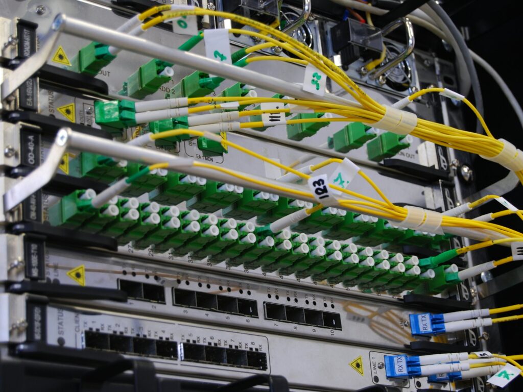 Fiber optic cables connected to a network switch in a server rack